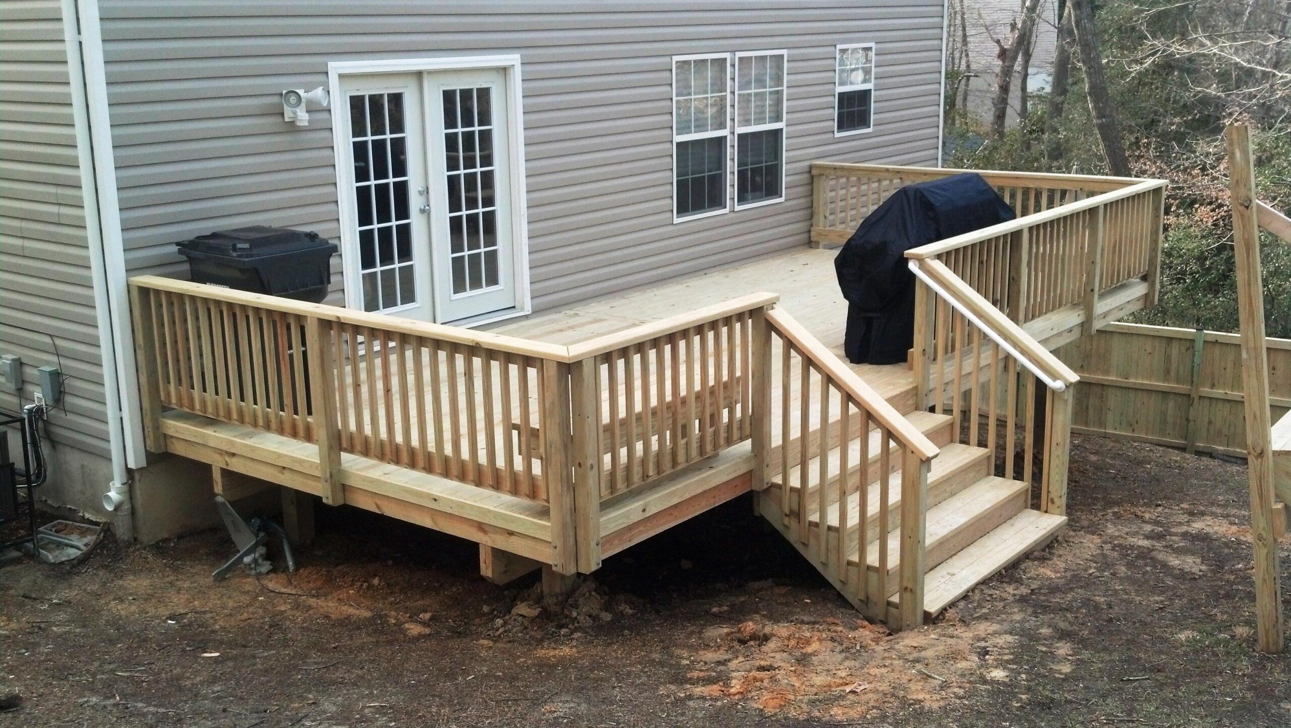 wood deck covered grill gray house white trim